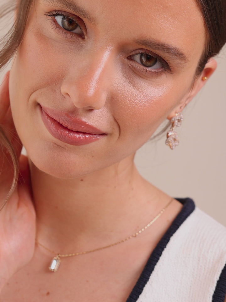 Pair of gold drop earrings with crystal-like stones