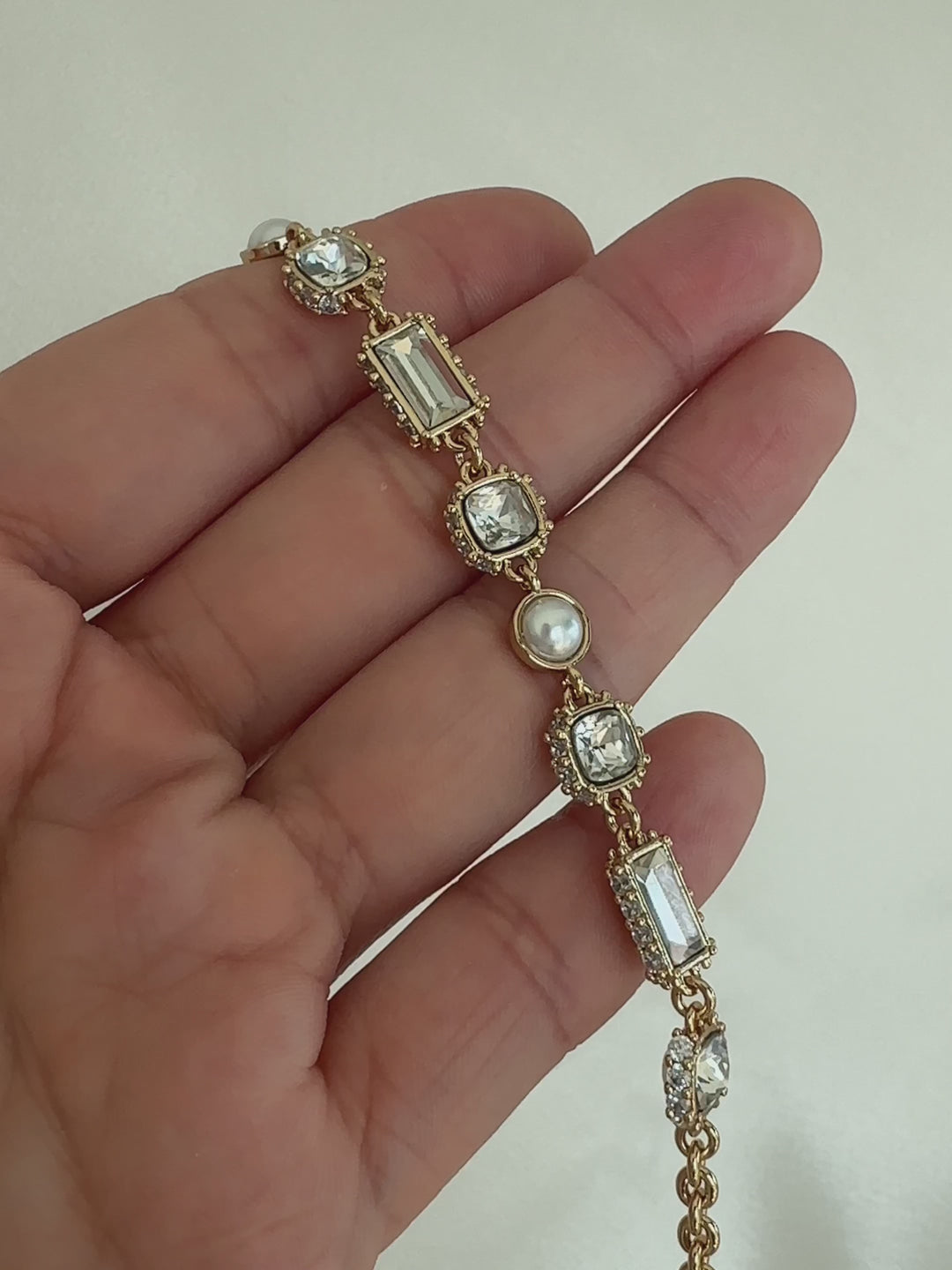 Gold bracelet with clear gemstones and pearls