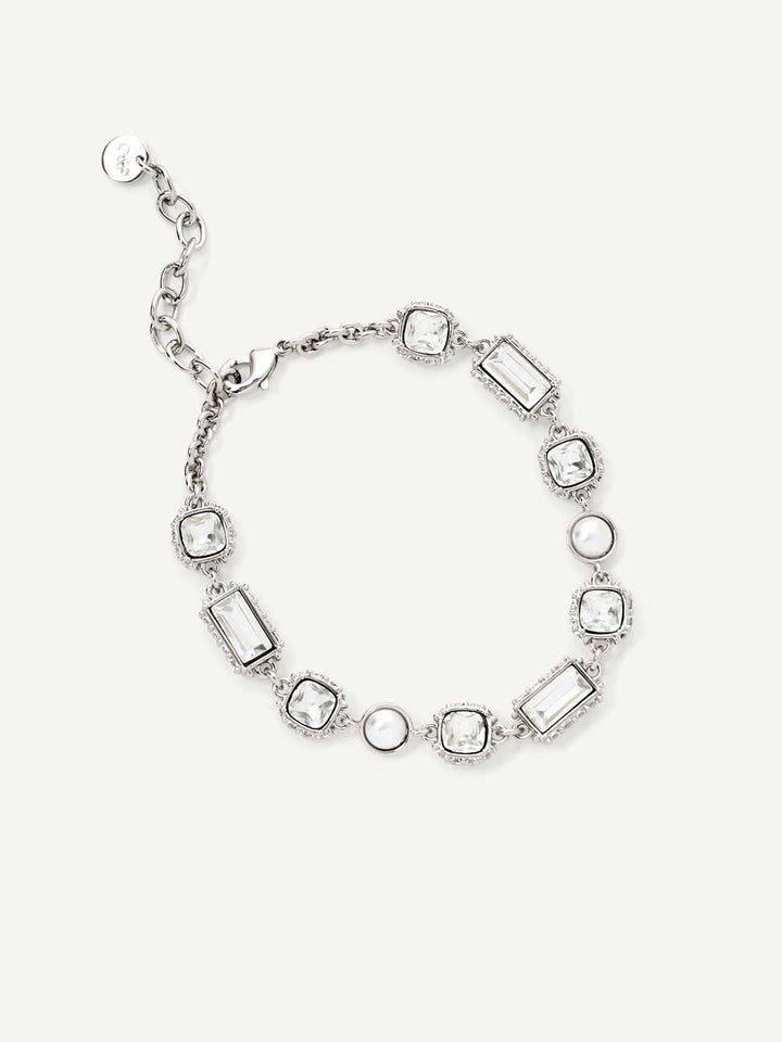 Silver bracelet with rectangular and round stones on a white background